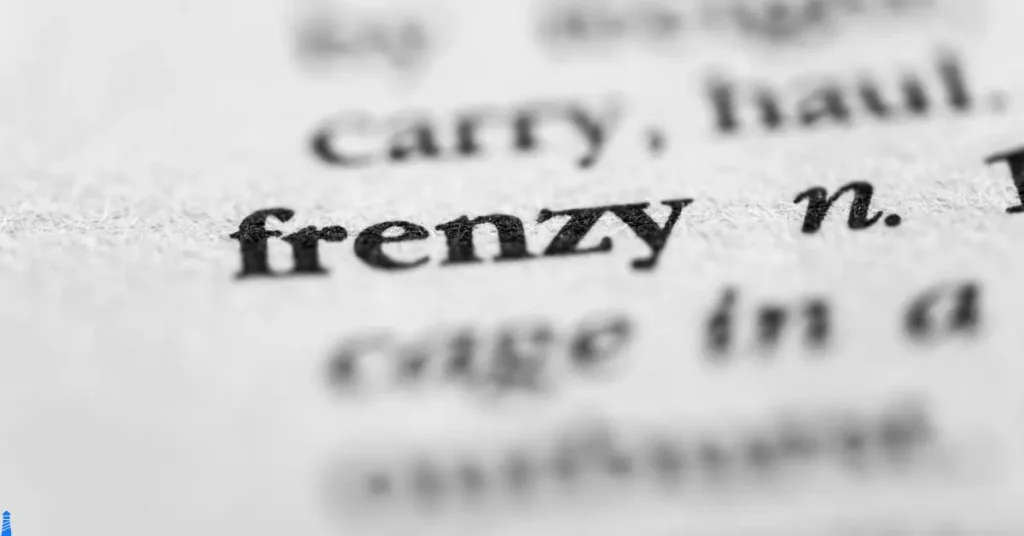 The word frenzy in a paper dictionary with the other words around it blurred out but visible.