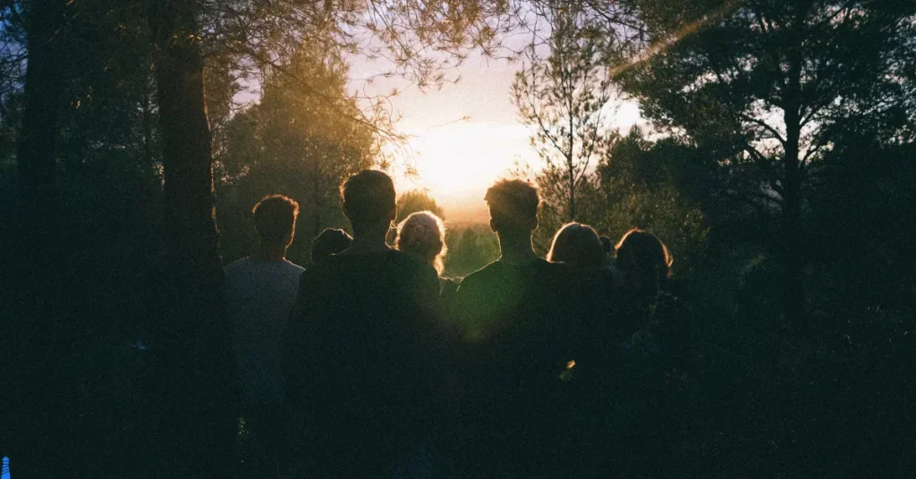 A group of friends watching a sunset.