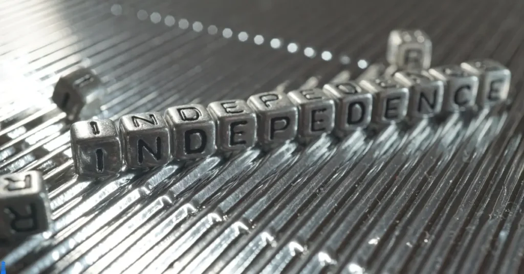The word independence spelled out on silver six sided blocks.