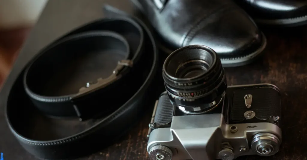 Old camera, leather belt, and leather shoes