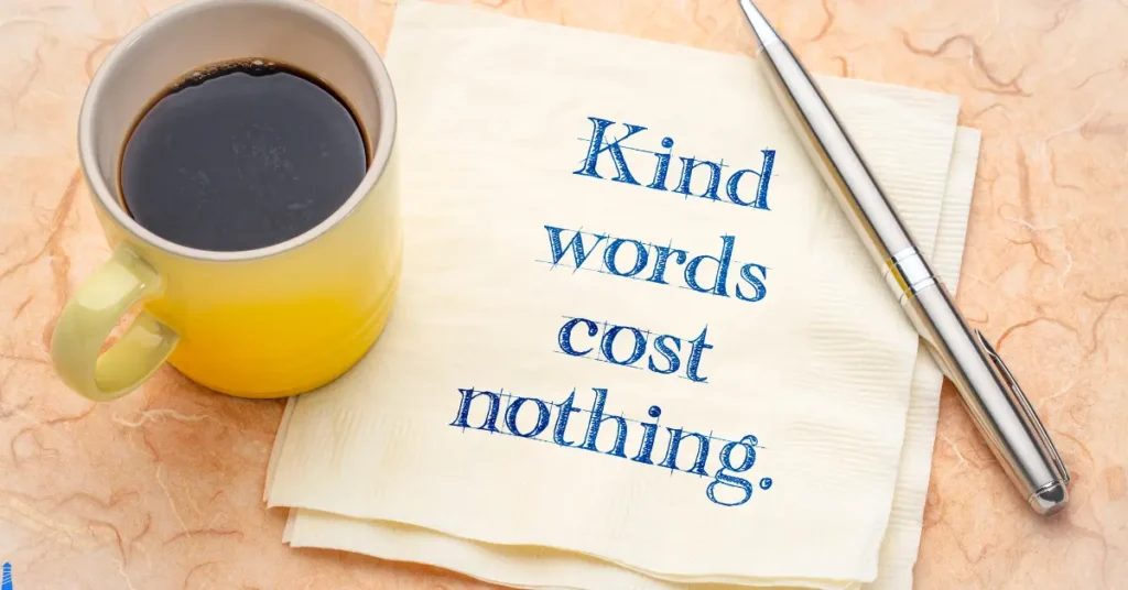 Kind words cost nothing written on a napkin in pen with a pen next to it with a coffee mug