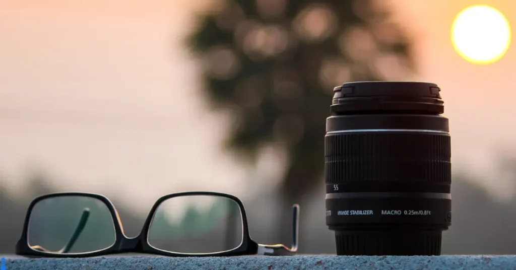 Lenses. A pair of glasses and a camera lens.